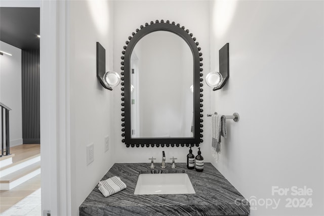 bathroom with vanity and hardwood / wood-style floors