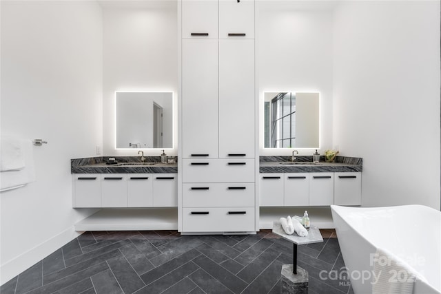 bathroom with a tub to relax in and vanity