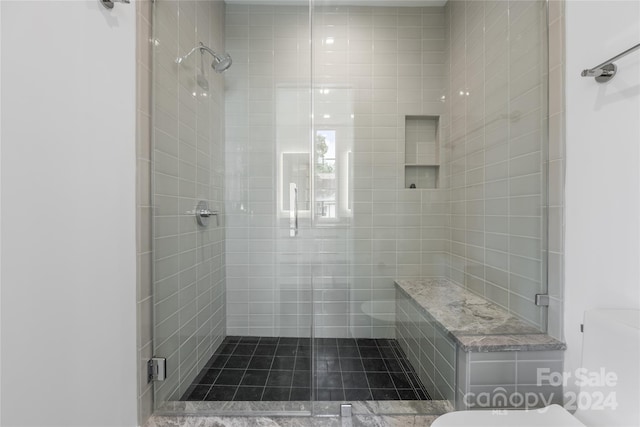 bathroom with toilet and a shower with shower door