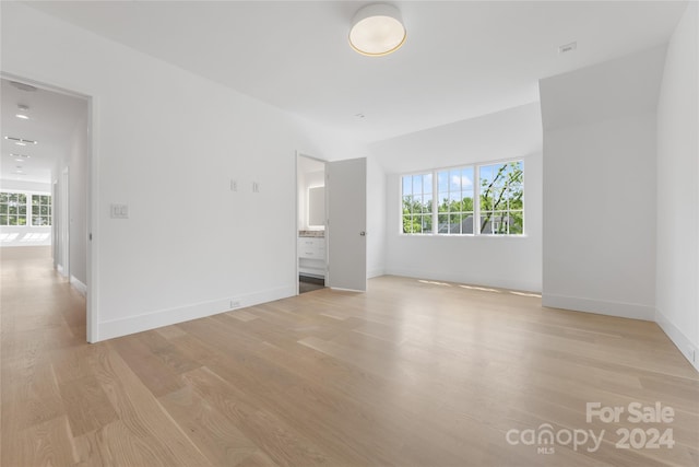 unfurnished room with light wood-type flooring and plenty of natural light