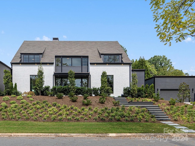 view of front facade with a front yard and a garage