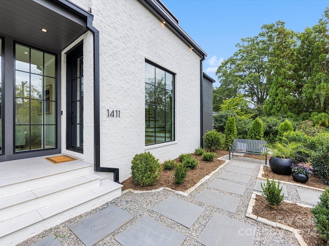 view of exterior entry featuring a patio