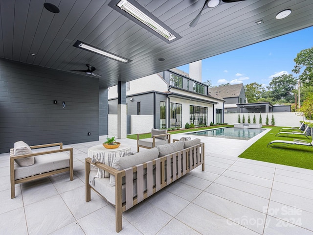 view of patio with ceiling fan, a fenced in pool, and an outdoor hangout area