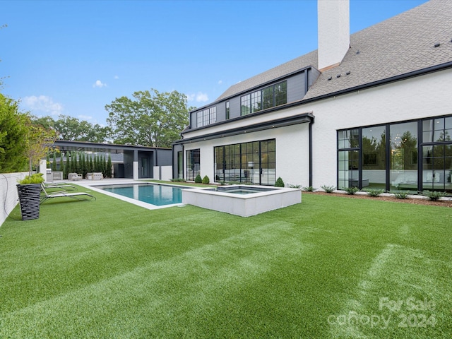 view of swimming pool with an in ground hot tub and a yard