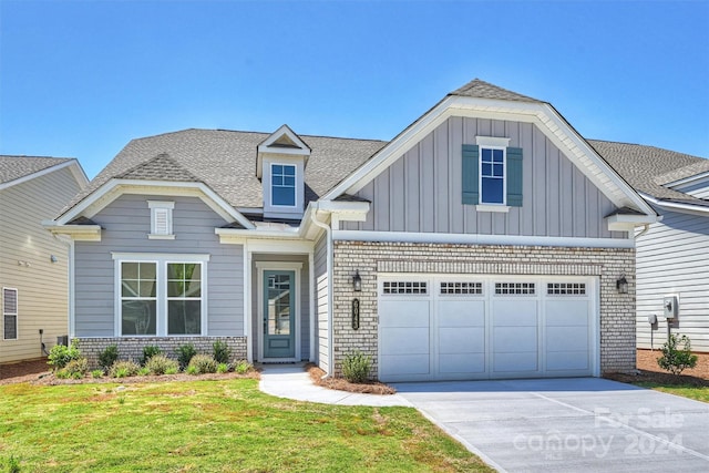 craftsman house with a garage and a front yard