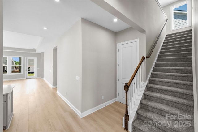 interior space featuring light wood-type flooring, stairway, baseboards, and recessed lighting