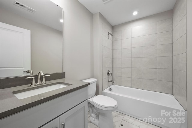 bathroom with toilet, vanity, visible vents, marble finish floor, and washtub / shower combination