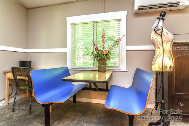 543 College St, Asheville, NC 28801 - living area with an AC wall unit, concrete flooring, and baseboards