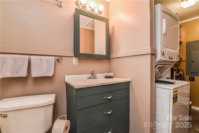 543 College St, Asheville, NC 28801 - bathroom featuring stacked washer / drying machine, electric panel, toilet, and vanity