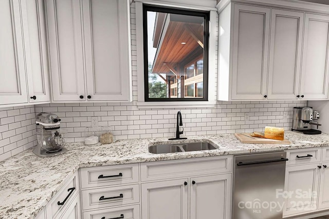 9999 Sourwood Rd, Canton, NC 28716 - kitchen with a sink, decorative backsplash, stainless steel dishwasher, light stone counters, and white cabinets