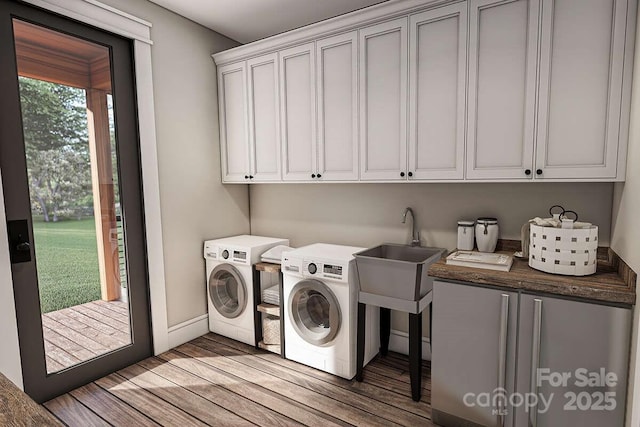 9999 Sourwood Rd, Canton, NC 28716 - laundry area with cabinet space, independent washer and dryer, light wood finished floors, and baseboards