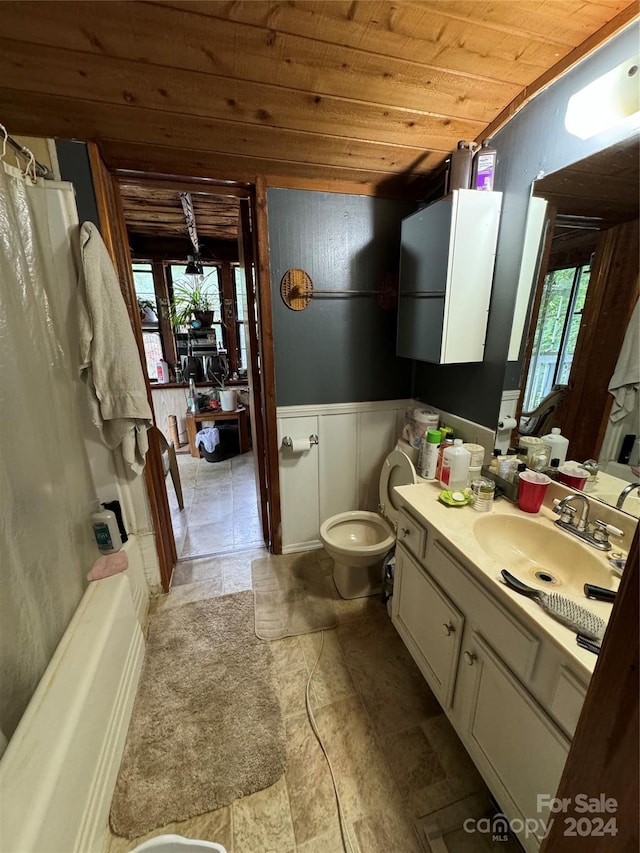 full bathroom with toilet, wood ceiling, vanity, and a healthy amount of sunlight