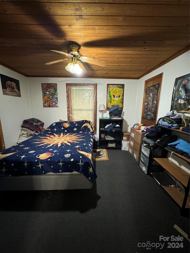 bedroom featuring carpet, wooden ceiling, and a ceiling fan