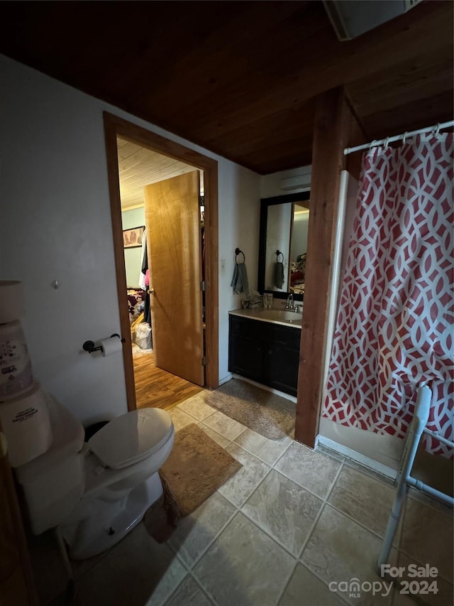 bathroom with toilet, wood ceiling, shower / tub combo with curtain, and vanity