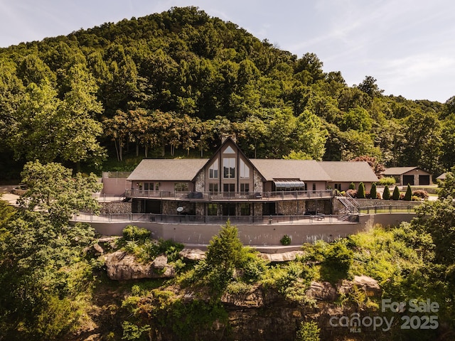 drone / aerial view featuring a wooded view