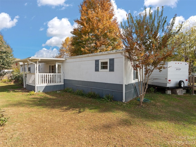 view of side of property with a lawn