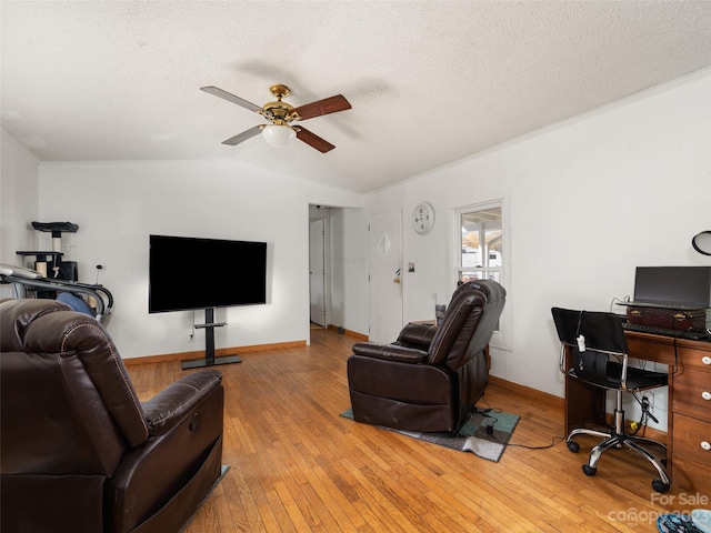 living room with light hardwood / wood-style floors, vaulted ceiling, ceiling fan, and a textured ceiling