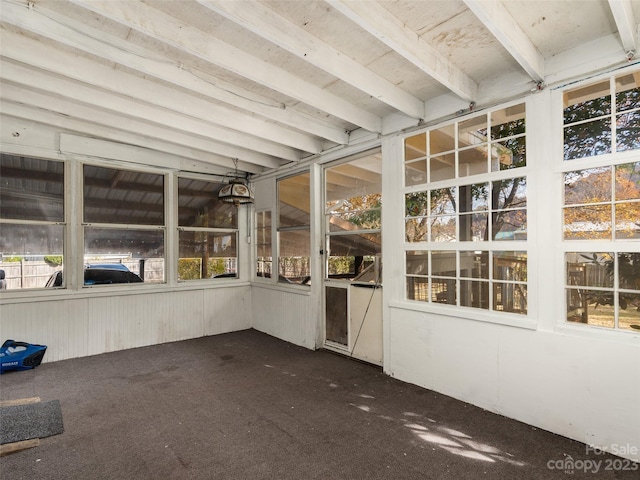 unfurnished sunroom with beam ceiling