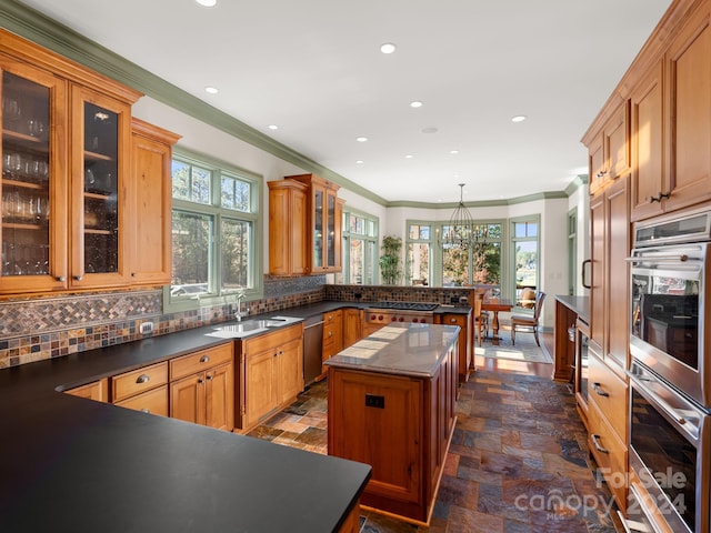 29 Elkton Dr, Pinehurst, NC 28374 - kitchen featuring appliances with stainless steel finishes, tasteful backsplash, a kitchen island, and dark tile flooring