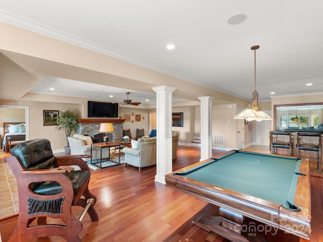 29 Elkton Dr, Pinehurst, NC 28374 - playroom with ceiling fan, a stone fireplace, pool table, hardwood / wood-style floors, and ornate columns