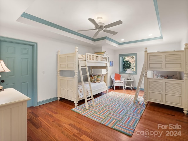 29 Elkton Dr, Pinehurst, NC 28374 - bedroom with wood-type flooring, ceiling fan, and a tray ceiling