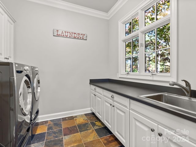 29 Elkton Dr, Pinehurst, NC 28374 - clothes washing area with plenty of natural light, cabinets, dark tile floors, and washer and clothes dryer