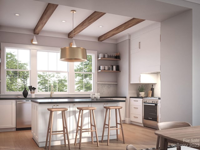 kitchen featuring backsplash, stainless steel appliances, decorative light fixtures, and white cabinetry