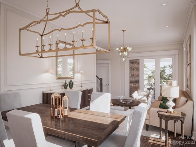 dining space featuring a notable chandelier and crown molding