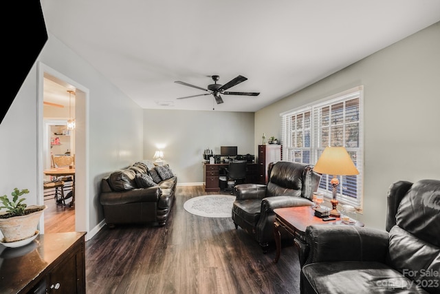 living room with ceiling fan and dark hardwood / wood-style flooring