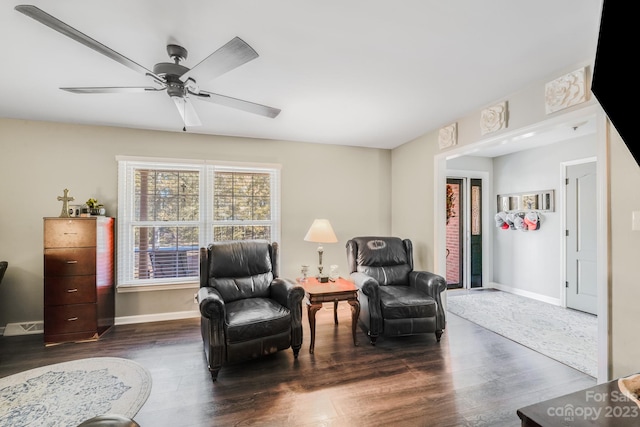 sitting room featuring dark hardwood / wood-style floors and ceiling fan