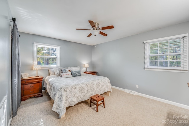 bedroom with light colored carpet and ceiling fan