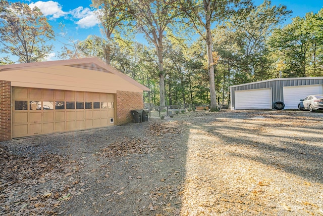 view of home's exterior with an outdoor structure and a garage