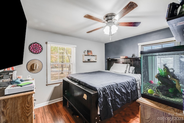 bedroom with ceiling fan and dark hardwood / wood-style flooring