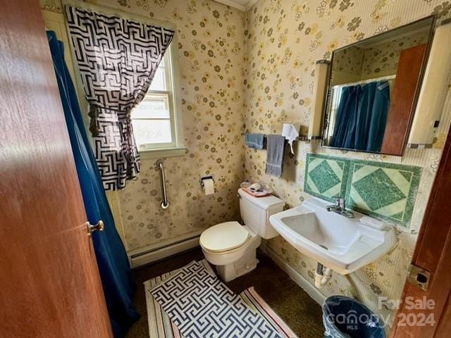 bathroom with toilet, a baseboard radiator, and sink