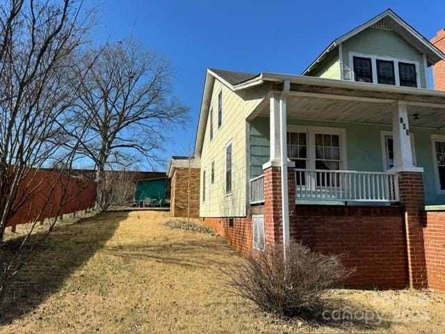 view of side of property with a porch