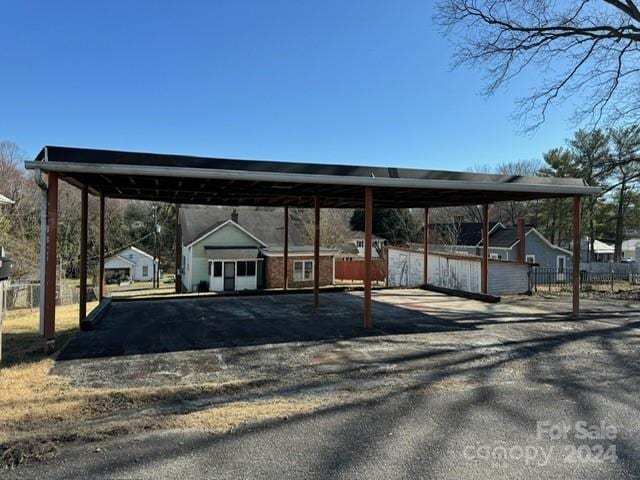 view of parking / parking lot with a carport