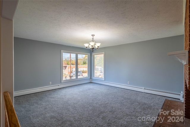 interior space featuring a textured ceiling, dark carpet, baseboard heating, and an inviting chandelier