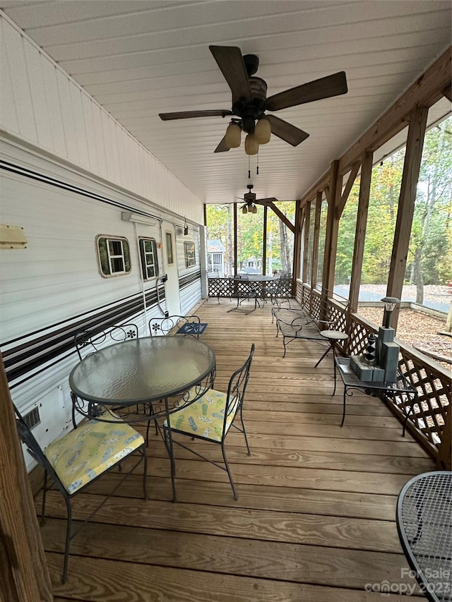 wooden deck featuring ceiling fan