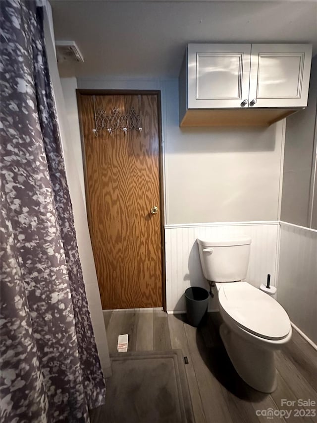 bathroom featuring hardwood / wood-style floors and toilet