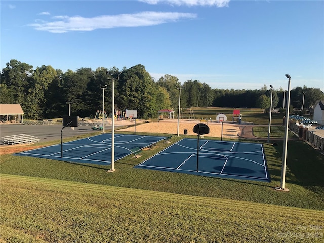 view of sport court with a yard