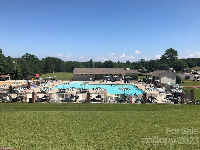 view of pool featuring a yard and a patio area