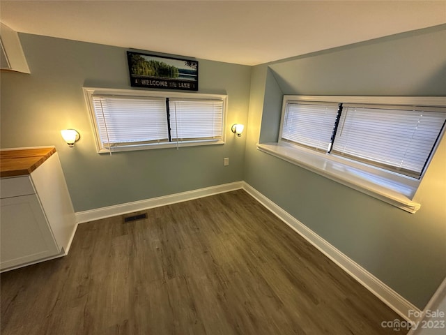 unfurnished room with dark hardwood / wood-style flooring