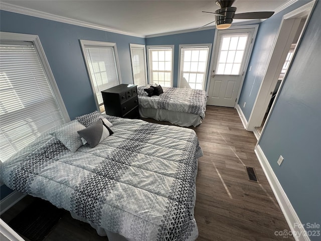 bedroom featuring dark hardwood / wood-style floors, ornamental molding, and ceiling fan