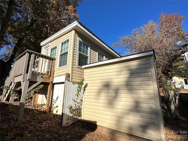 view of home's exterior with a wooden deck