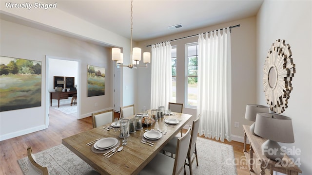 dining room featuring light hardwood / wood-style flooring and a chandelier