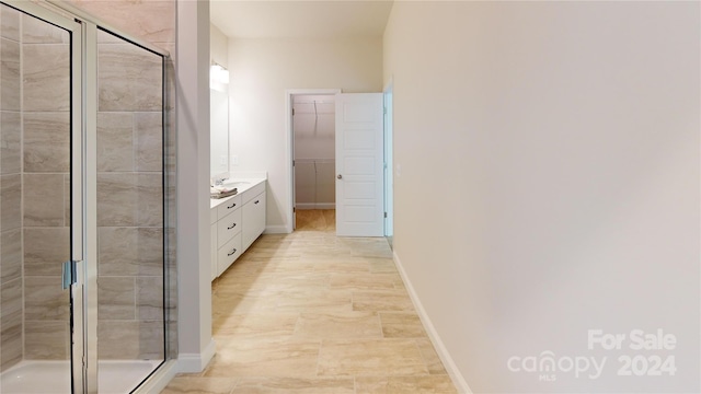 bathroom featuring vanity and a shower with shower door