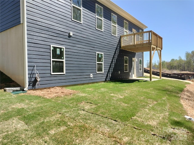 back of house with a yard and a wooden deck