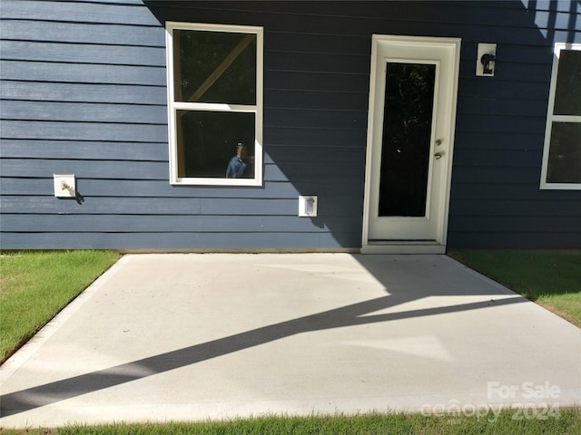 entrance to property featuring a patio