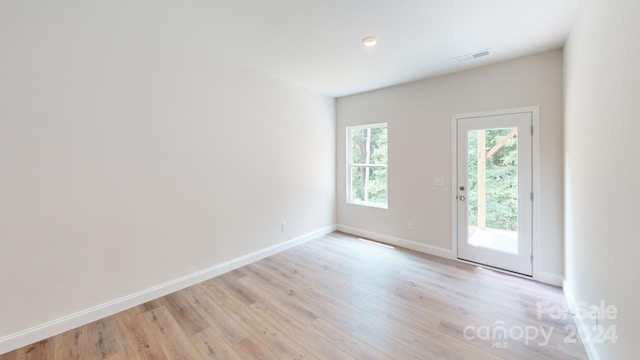 spare room with light hardwood / wood-style flooring