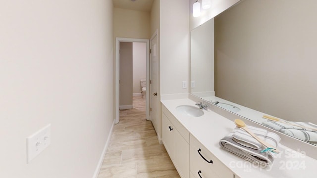 bathroom featuring vanity and toilet